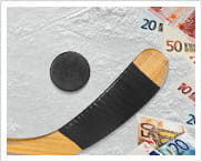Alcune banconote di tagli diversi e una mazza da hockey con un disco.